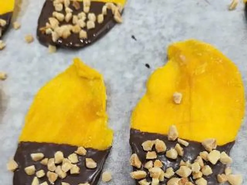 Chocolate-dipped dried mango with nut topping — KHAMACO.