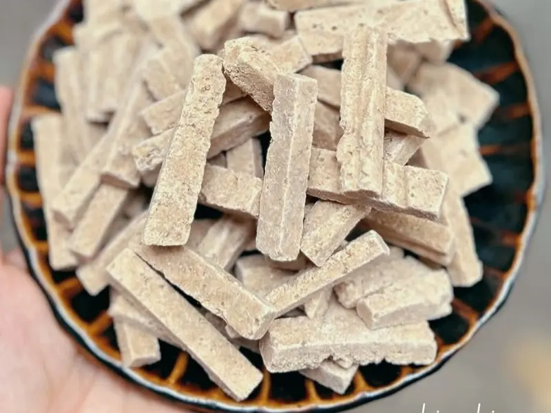 Soft-dried ginger strips in a woven basket, KHAMACO Vietnam