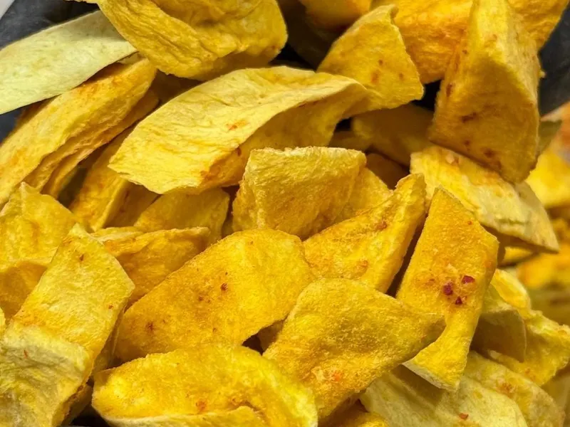 Close-up of thick, deep yellow freeze-dried mango chunks.