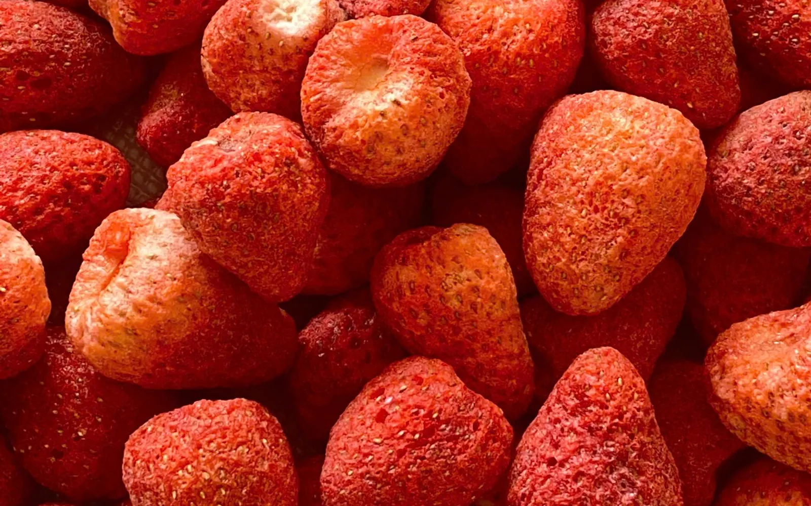 Full-frame close-up of whole freeze-dried strawberries.