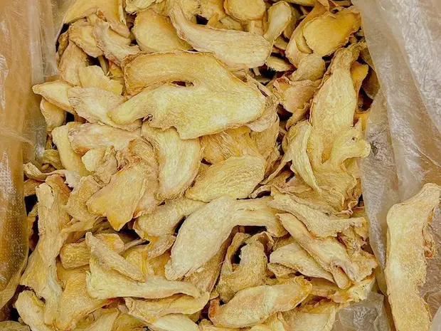 Bulk dried ginger slices in a clear plastic liner bag.