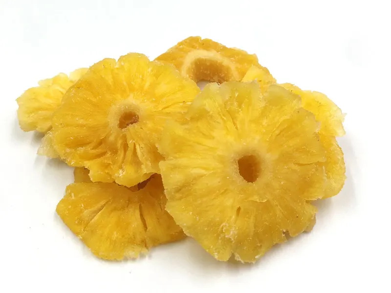 Soft-dried pineapple rings photographed on a plain white background